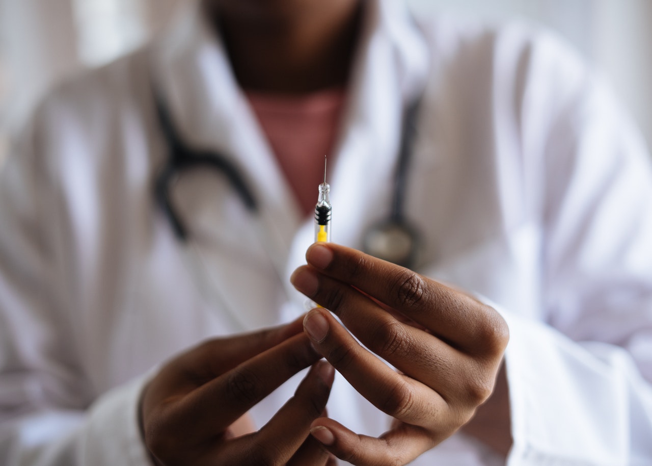 doctor holding an injection needle