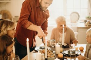 family having thanksgiving dinner with grandma